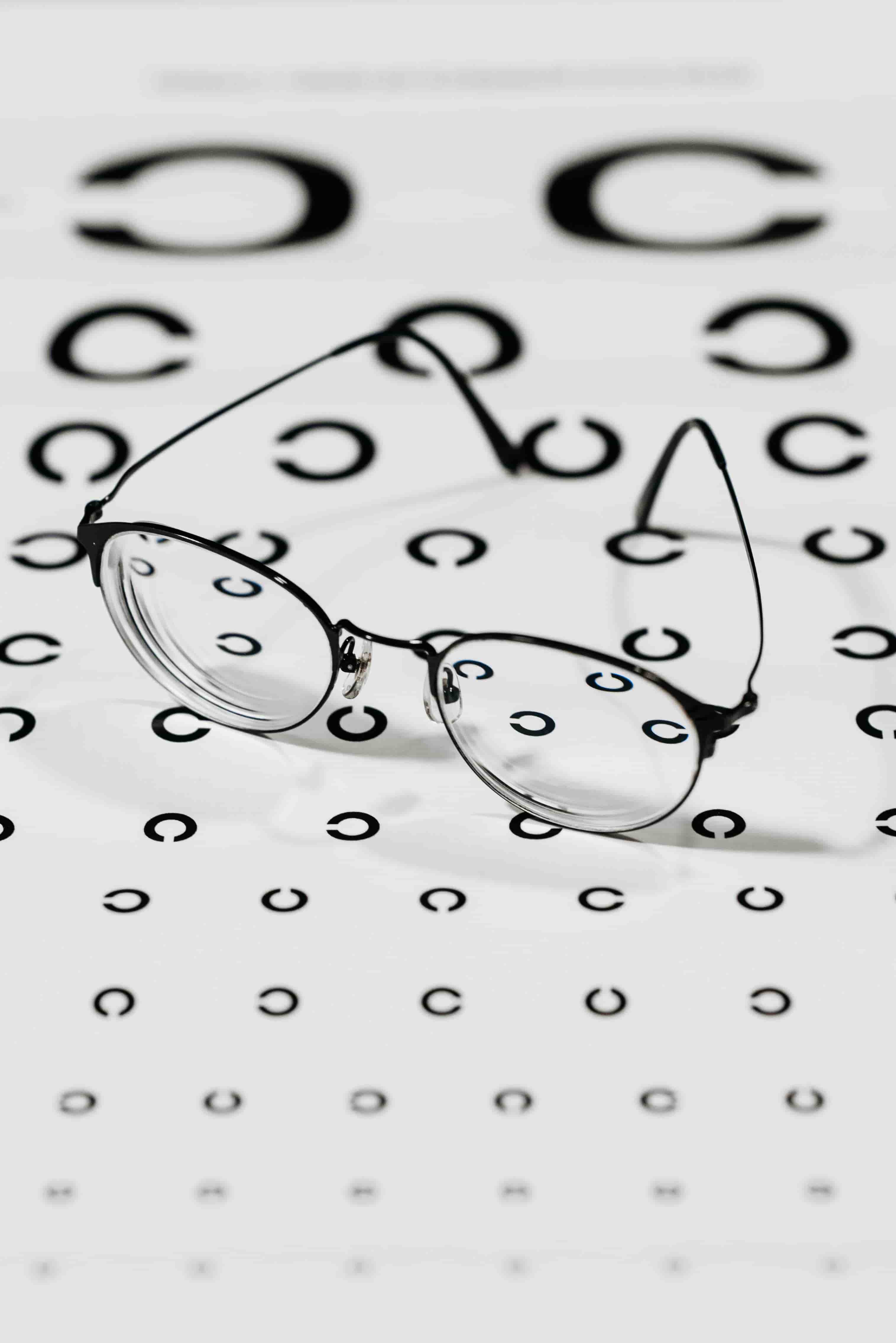 Black Framed Eyeglasses on White Paper With Printed Pattern